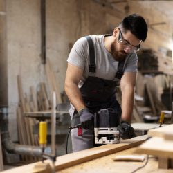 carpenter-cutting-mdf-board-inside-workshop